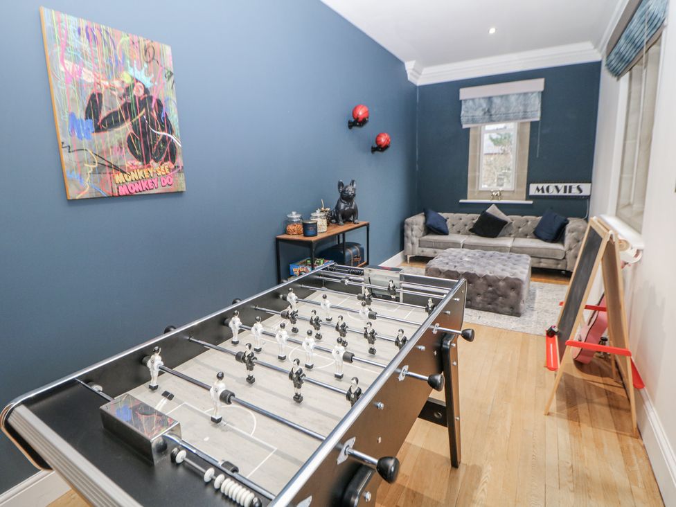 A snug with a foosball table and a sofa at Hallfield Hall in Shirland near Higham