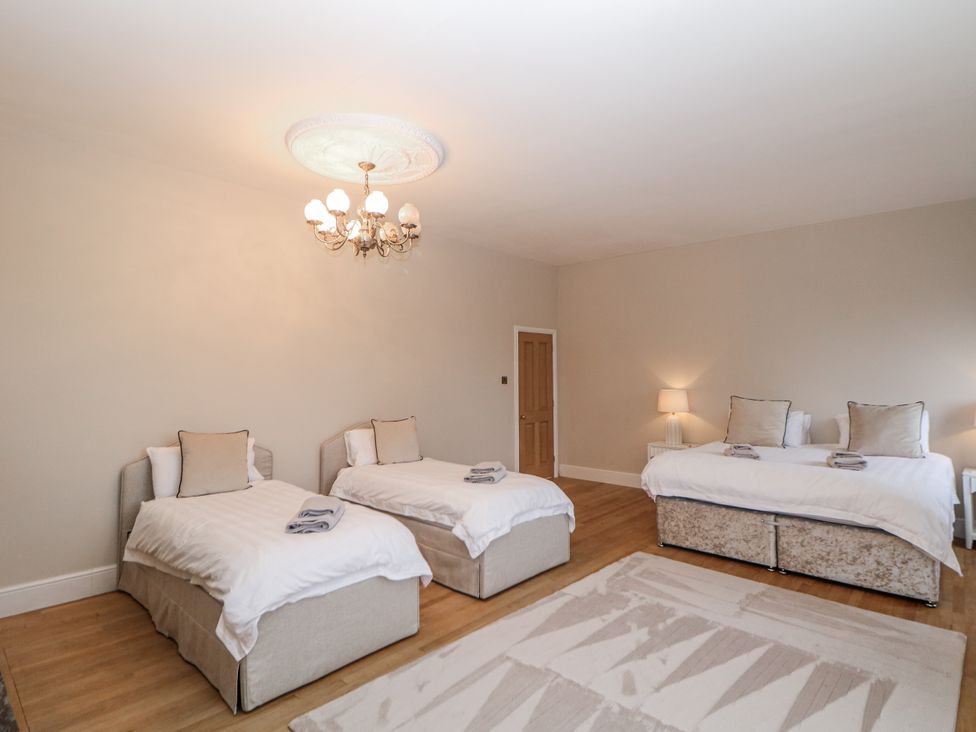 A bedroom with two beds and a lamp at Hallfield Hall Shirland near Higham
