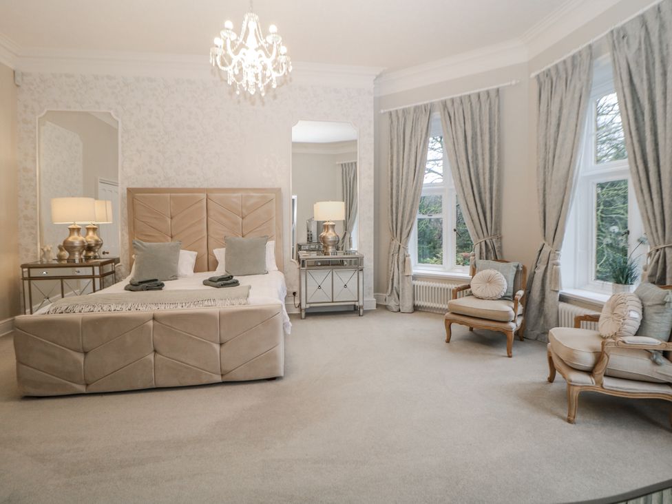 A bedroom with a bed and windows at Hallfield Hall in Shirland near Higham
