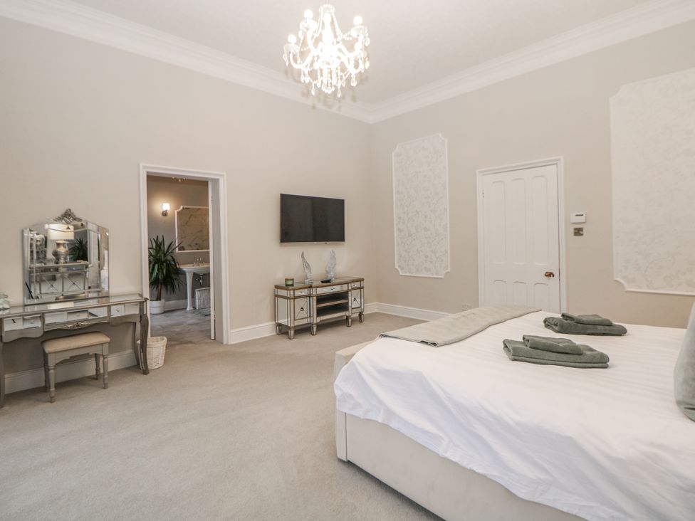 A bedroom with a bed, television, and a mirror at Hallfield Hall in Shirland near Higham