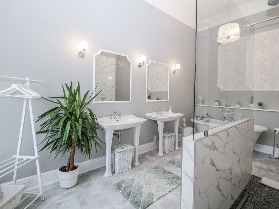 A bathroom with sinks and mirrors at Hallfield Hall in Shirland near Higham