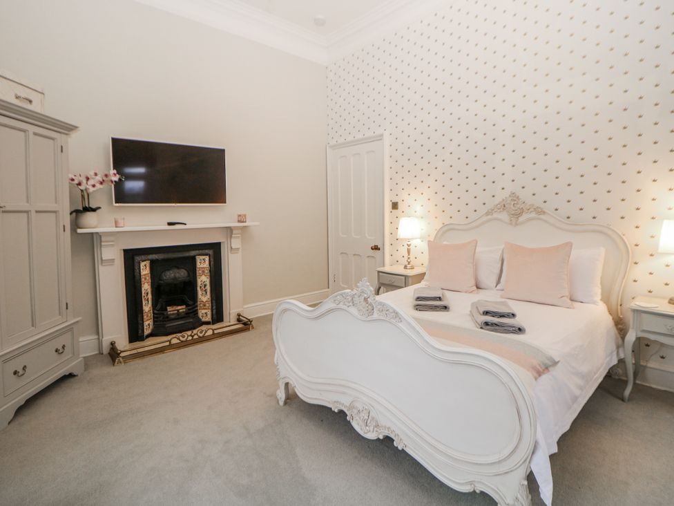 A bedroom with a bed and a television at Hallfield Hall in Shirland near Higham