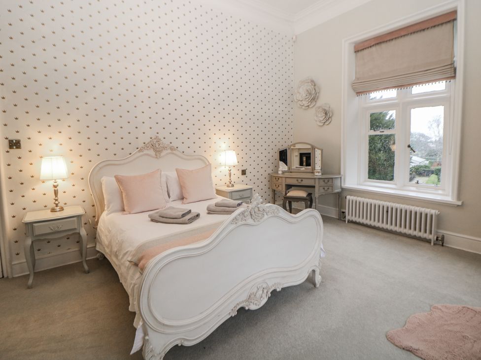 A bedroom with a bed and a table at Hallfield Hall Shirland near Higham