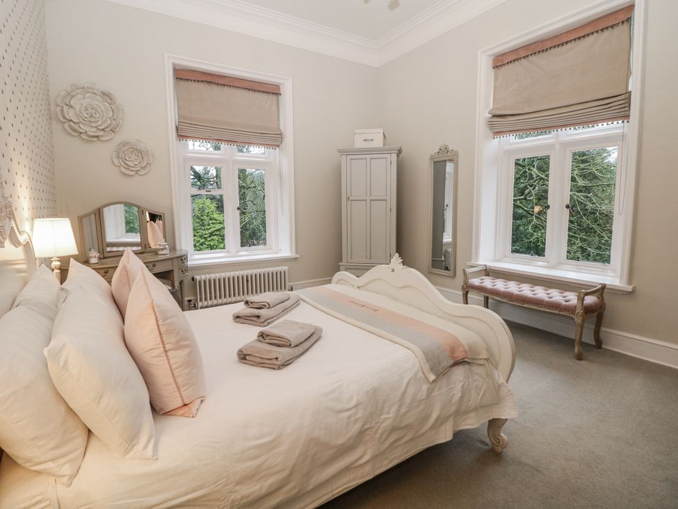 A bedroom with a bed and wardrobe at Hallfield Hall Shirland near Higham