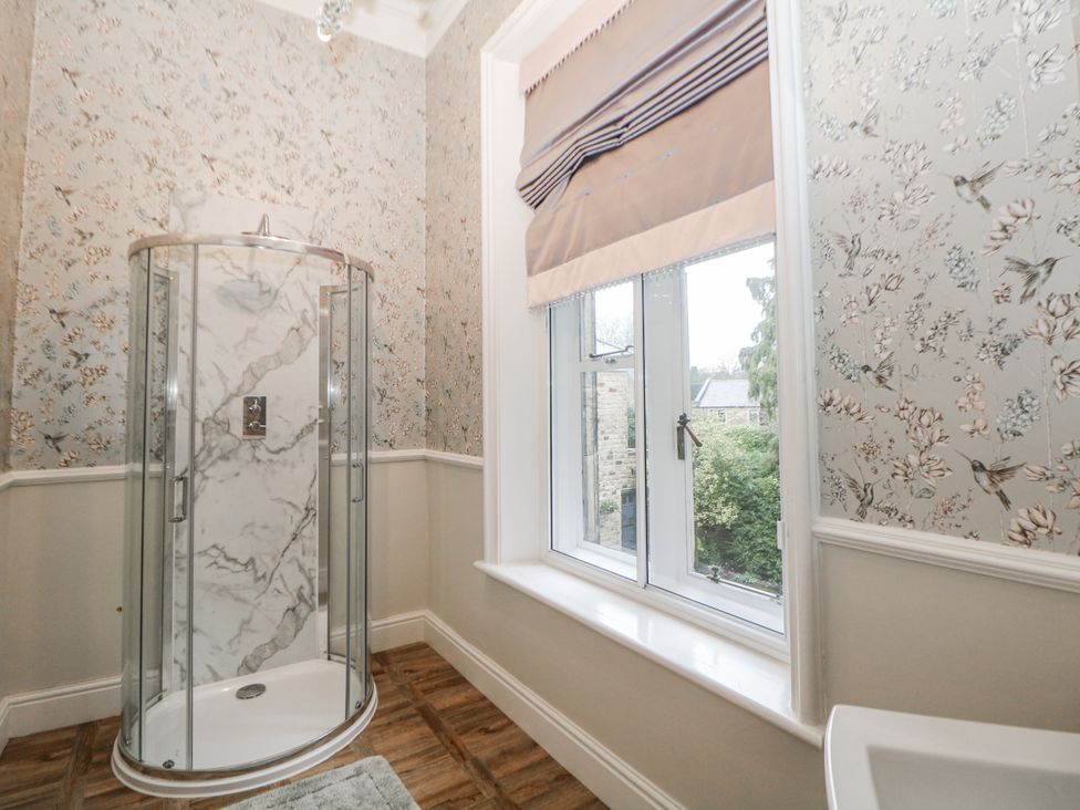 A bathroom with a shower and window at Hallfield Hall Shirland near Higham