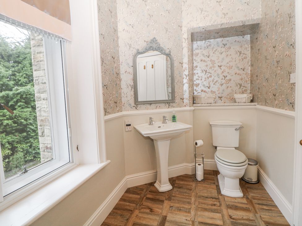A bathroom with a sink and toilet at Hallfield Hall Shirland near Higham
