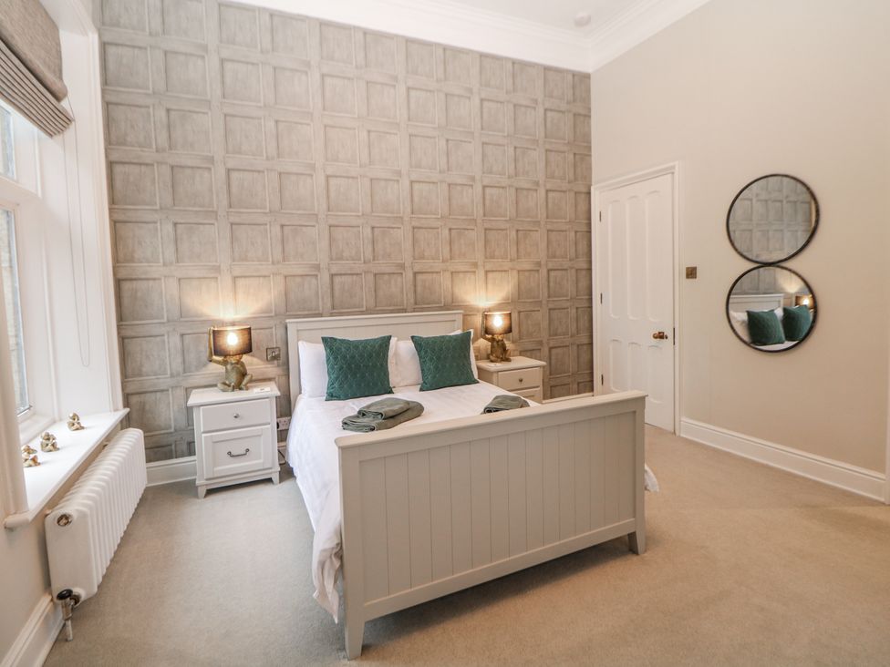 A bedroom with a bed and nightstand at Hallfield Hall in Shirland near Higham