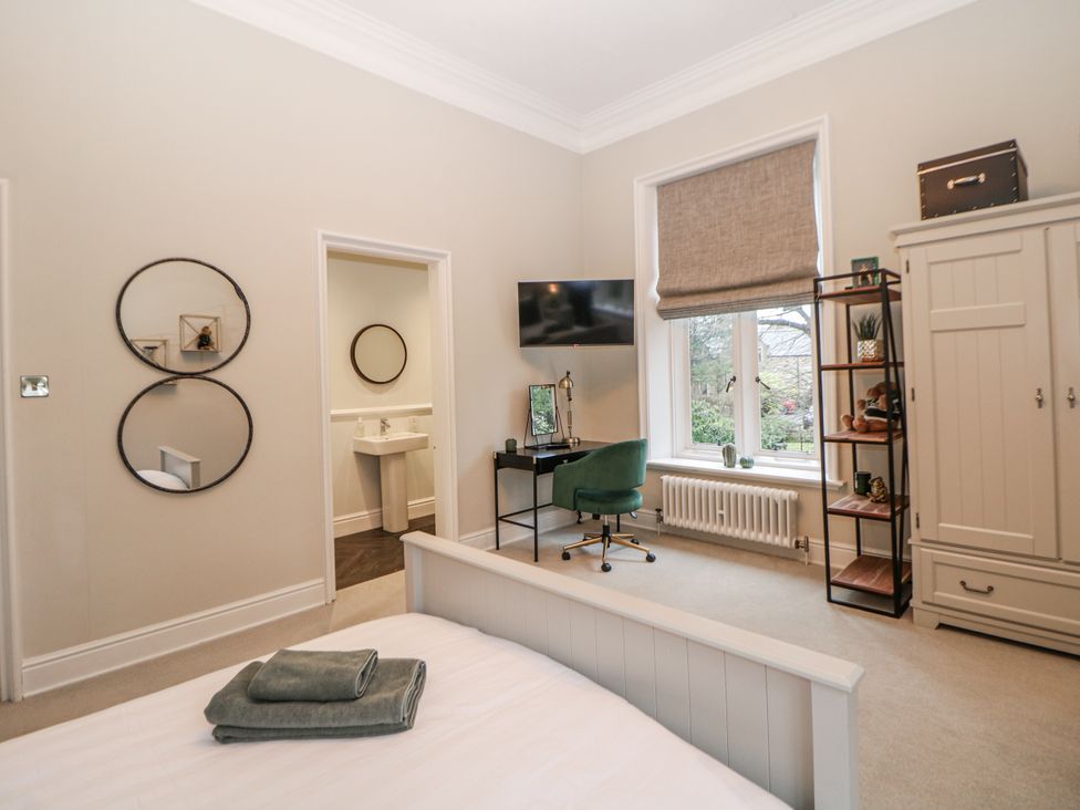 A bedroom with a desk and a TV at Hallfield Hall in Shirland near Higham