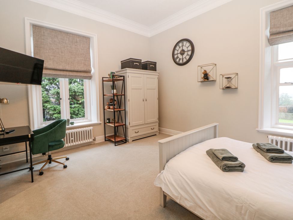 A bedroom with a bed and desk at Hallfield Hall in Shirland near Higham