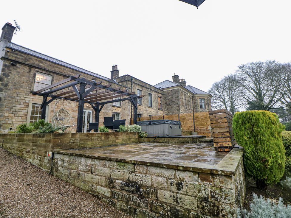 An outdoor space featuring a house with a garden at Hallfield Hall Cottage in Shirland