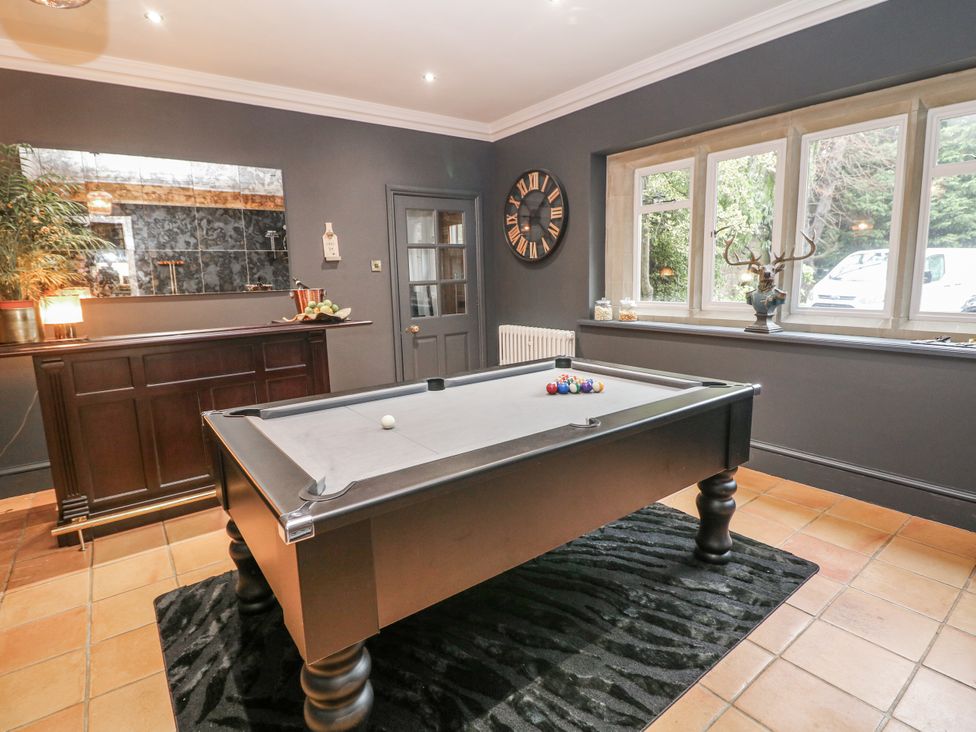 A game room with a pool table and bar at Hallfield Hall Cottage Shirland