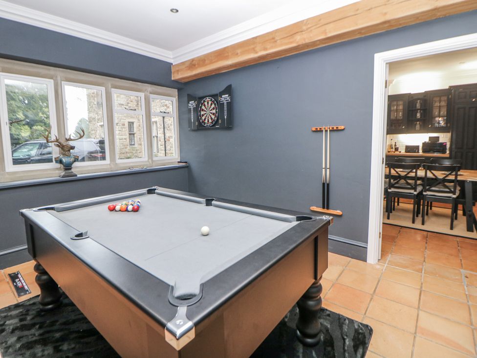 A snug with a pool table and darts board at Hallfield Hall Cottage in Shirland