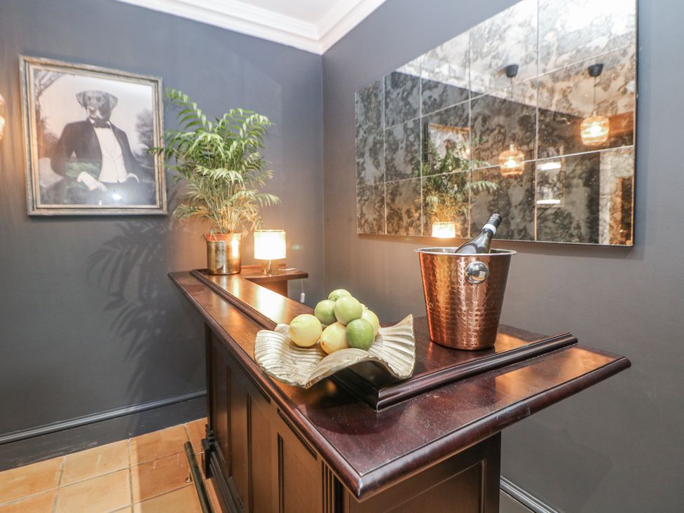 A hallway with a bar and light fixtures at Hallfield Hall Cottage in Shirland