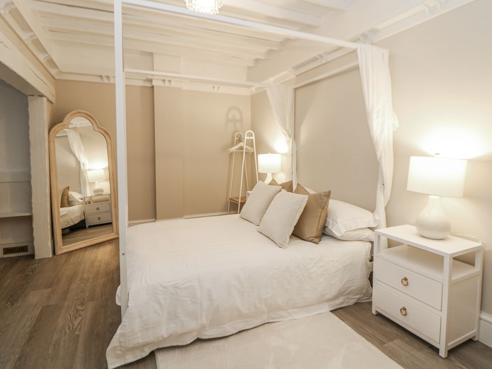 A bedroom with a bed and bedside table at Hallfield Hall Cottage in Shirland