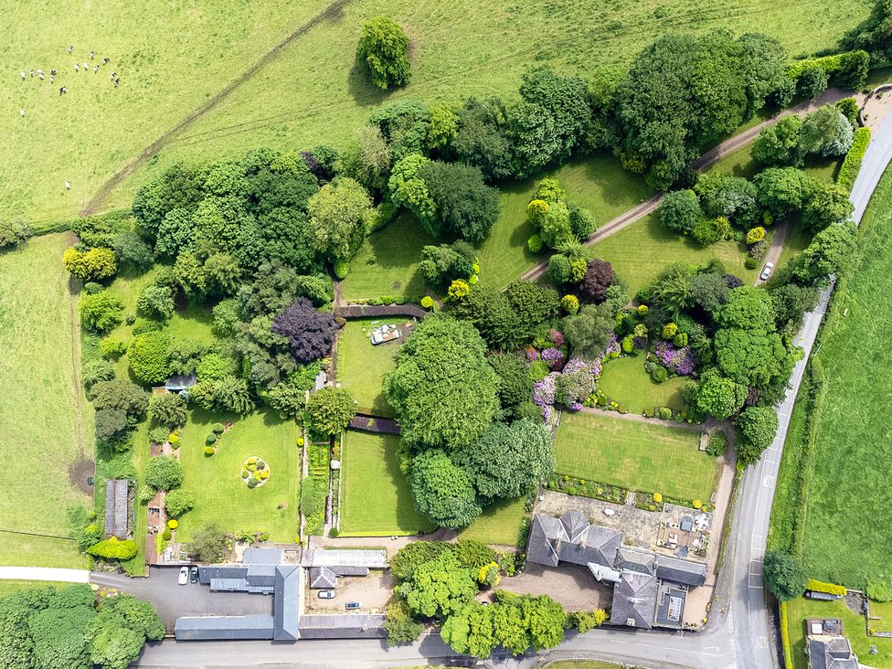 An aerial view of a garden with trees and pathways at Hallfield Hall Cottage in Shirland