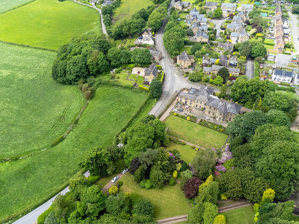 An aerial view of fields and houses at Hallfield Hall Cottage in Shirland