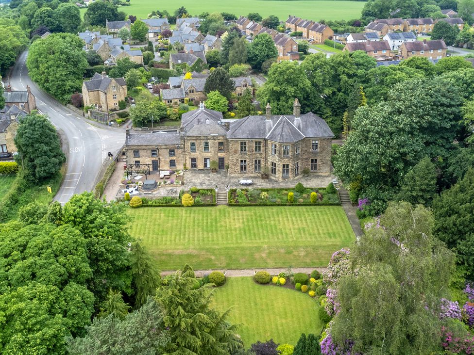 An aerial view of a large building and garden at Hallfield Hall Cottage in Shirland