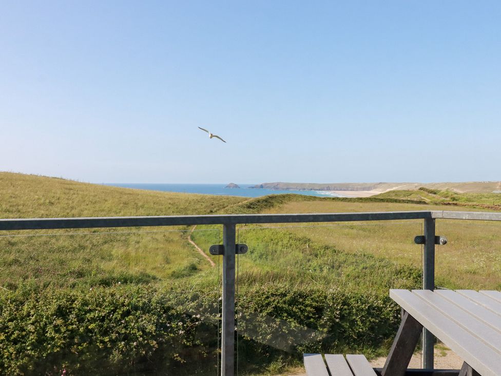 An outdoor view of the sea and hills from a balcony at Jacana in Perranporth