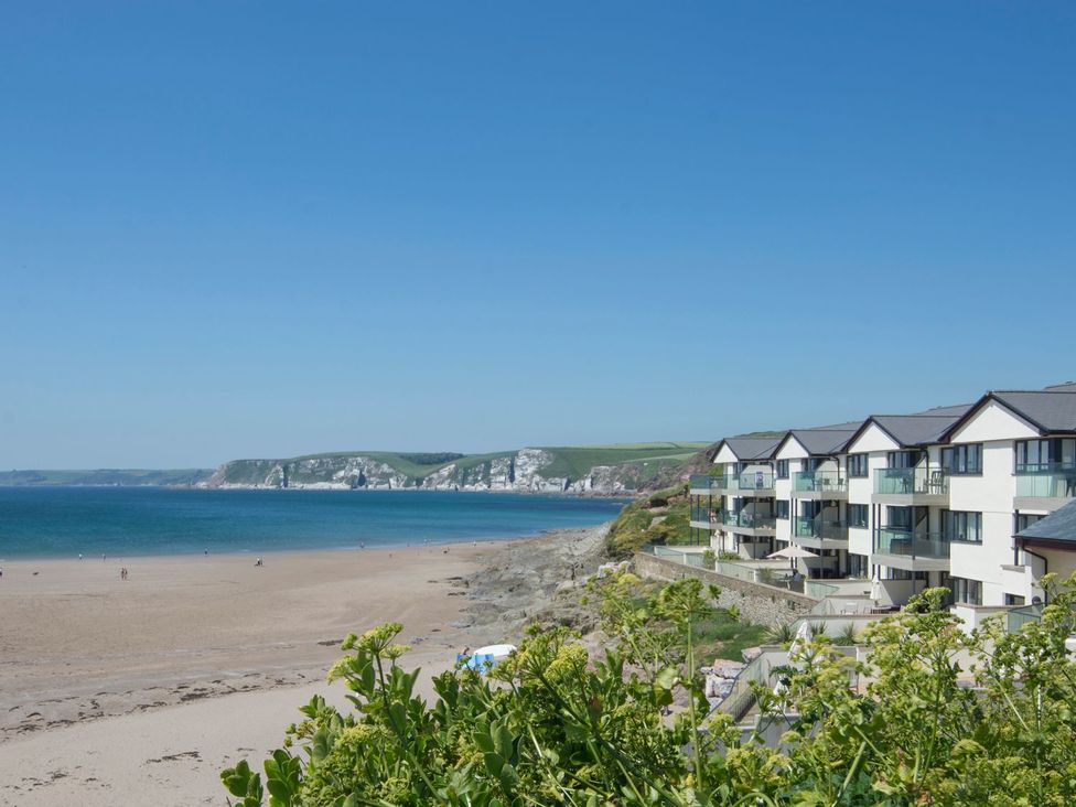 A beach with a building and ocean view at Apartment 12, Burgh Island Causeway Bigbury-On-Sea