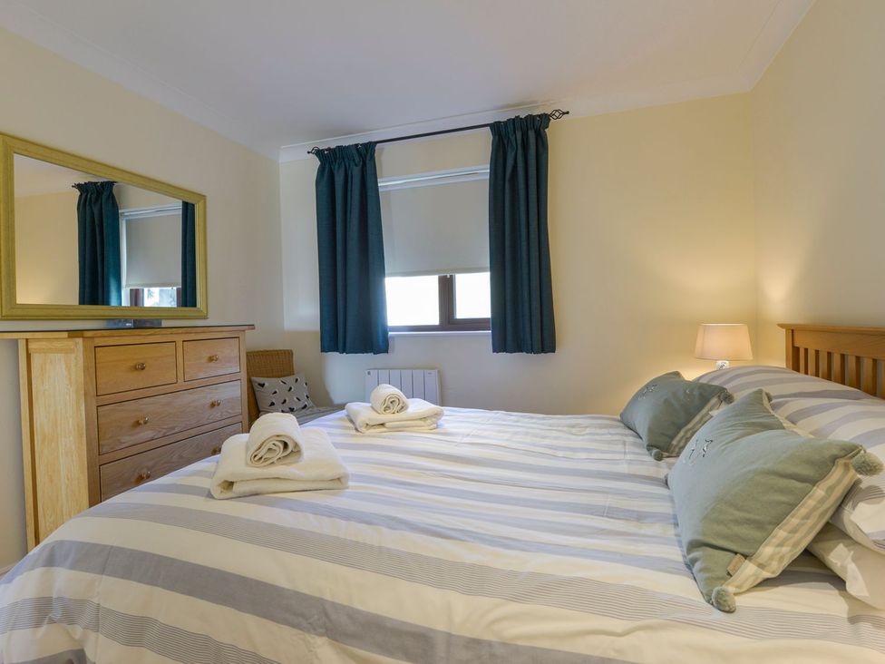 A bedroom with a bed and drawers at Apartment 12, Burgh Island Causeway Bigbury-On-Sea