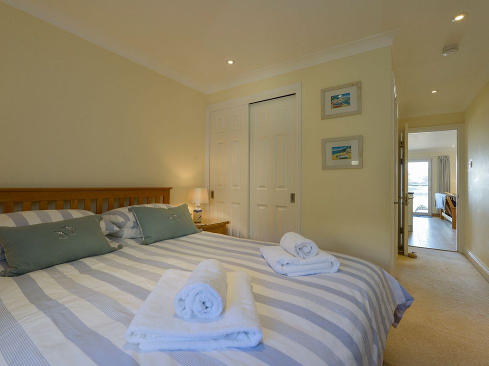 A bedroom with a bed and closet at Apartment 12, Burgh Island Causeway Bigbury-On-Sea