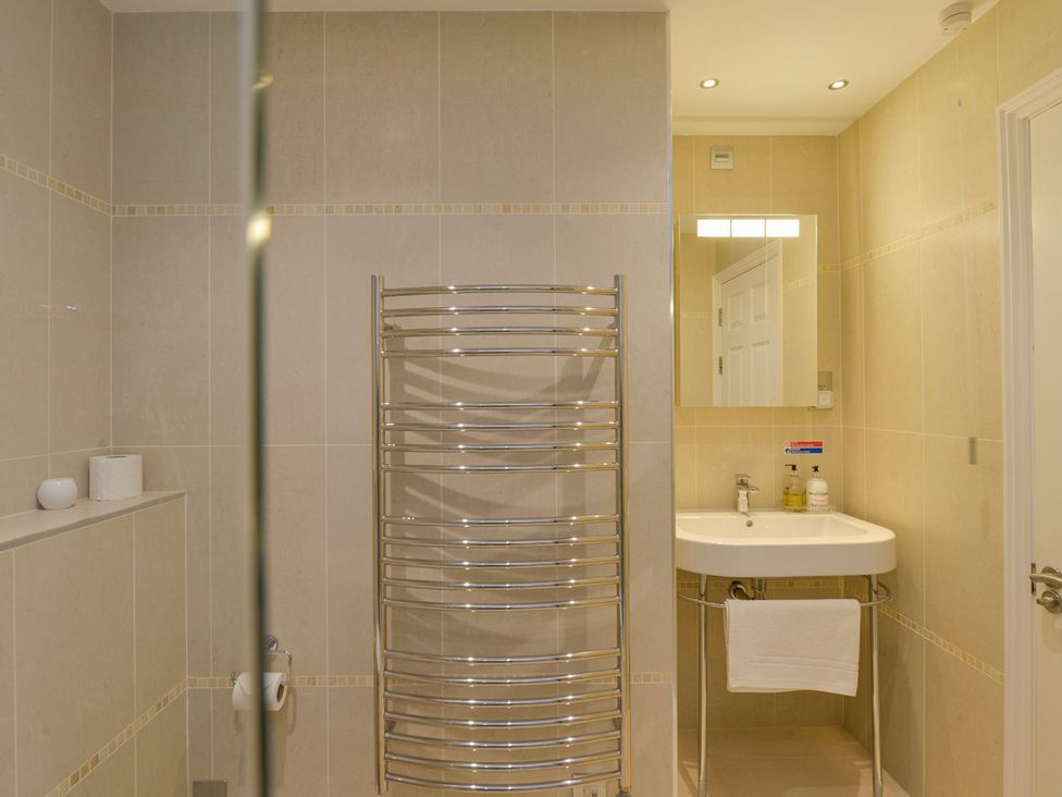 A bathroom with a towel radiator and sink at Apartment 12, Burgh Island Causeway, Bigbury-On-Sea