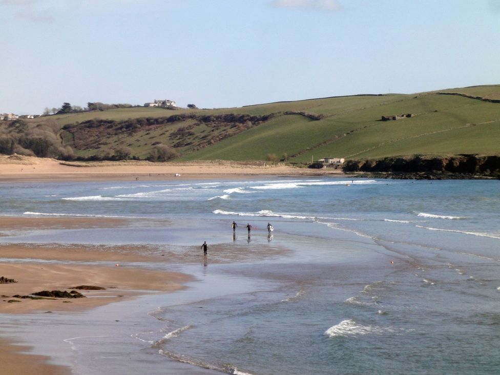 A beach with people walking along the shore at Apartment 12, Burgh Island Causeway Bigbury-On-Sea