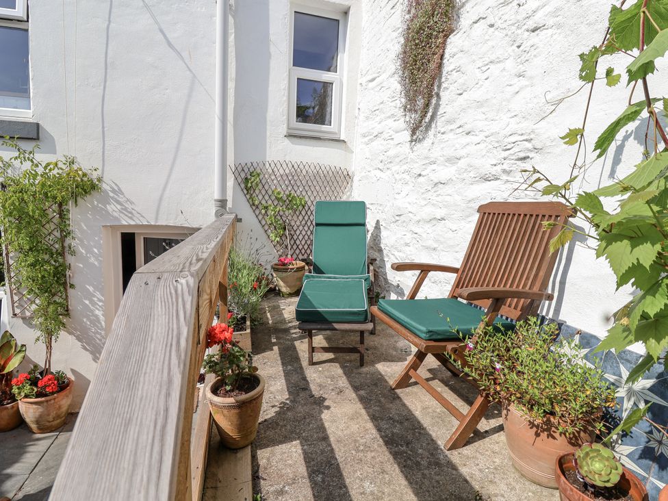 An outdoor area with two chairs and potted plants at Springfield in Kingsand