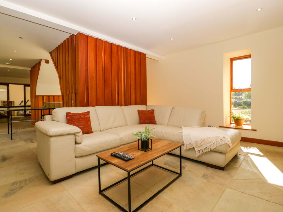 A living room with a sofa and coffee table at Heathcliffe House in Castleton near Cardiff