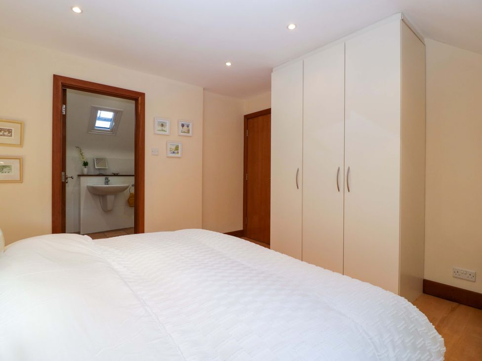 A bedroom with a bed and wardrobe at Heathcliffe House Caslteton near Cardiff