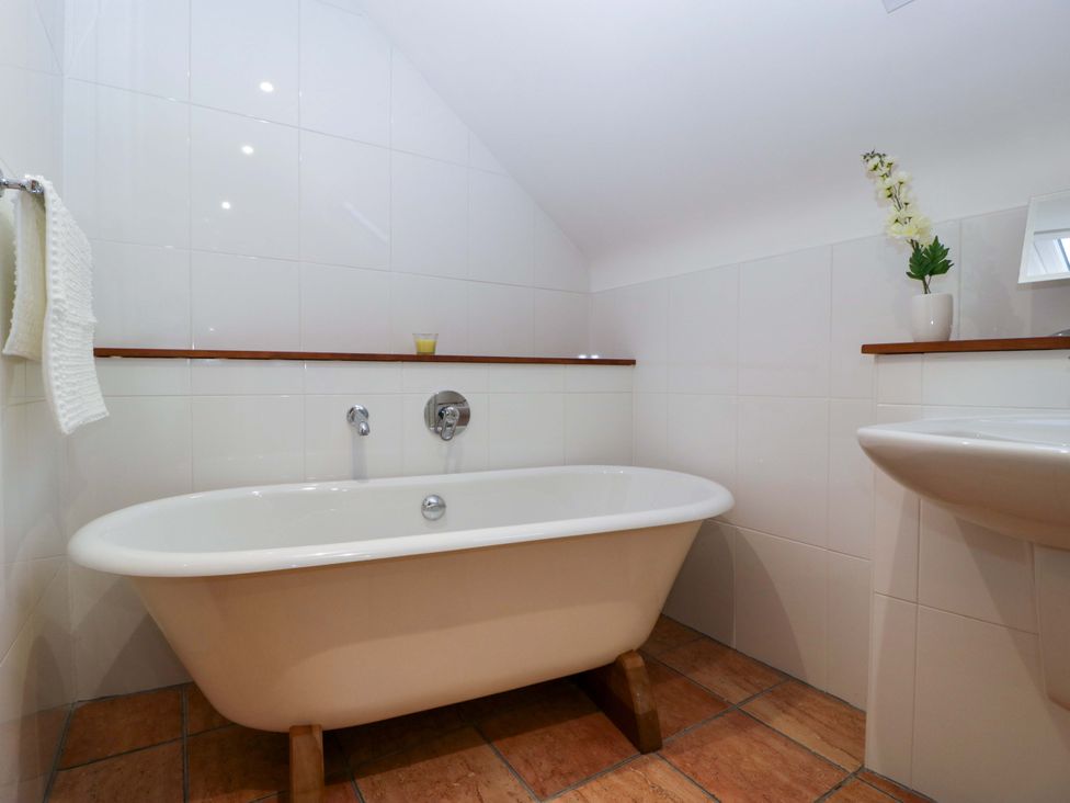 A bathroom with a bathtub and sink at Heathcliffe House Caslteton near Cardiff
