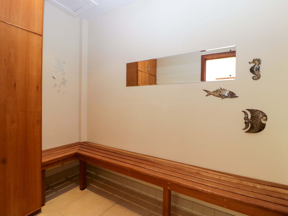 A hallway with a bench and a mirror at Heathcliffe House in Castleton near Cardiff