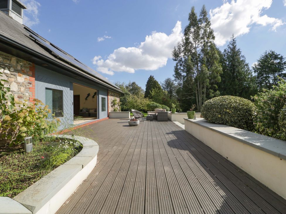 An outdoor deck with seating and plants at Heathcliffe House in Castleton near Cardiff