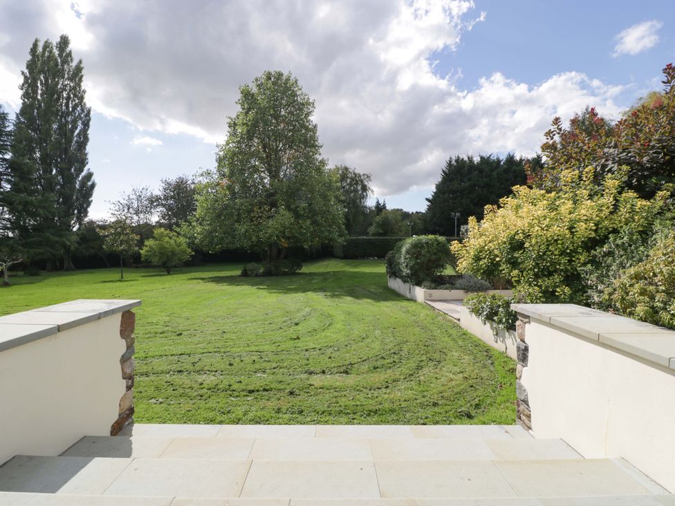 A garden with grass and trees at Heathcliffe House in Castleton near Cardiff