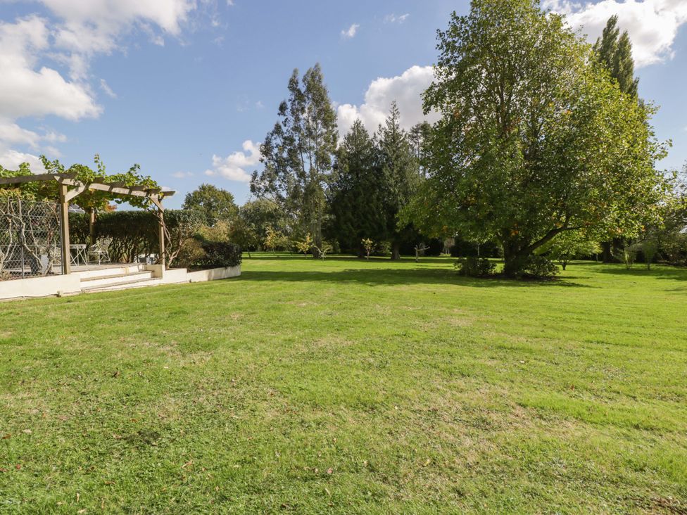 A garden with grass and trees at Heathcliffe House in Castleton near Cardiff