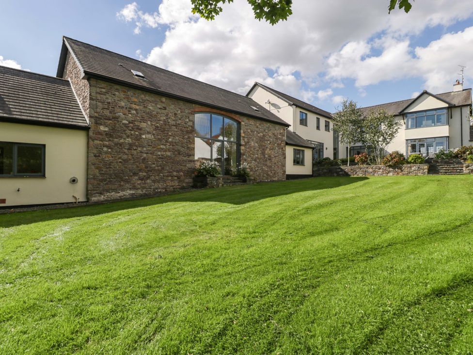 An outdoor view of a house with a lawn at Heathcliffe House, Caslteton near Cardiff