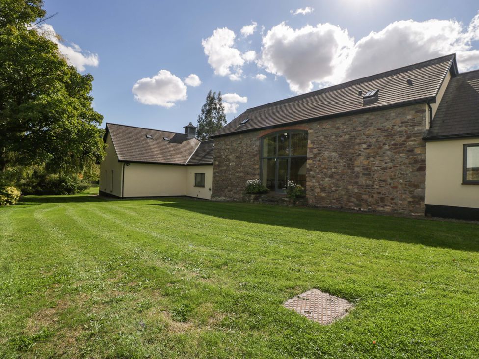 An outdoor view of a house with a garden at Heathcliffe House in Castletown near Cardiff