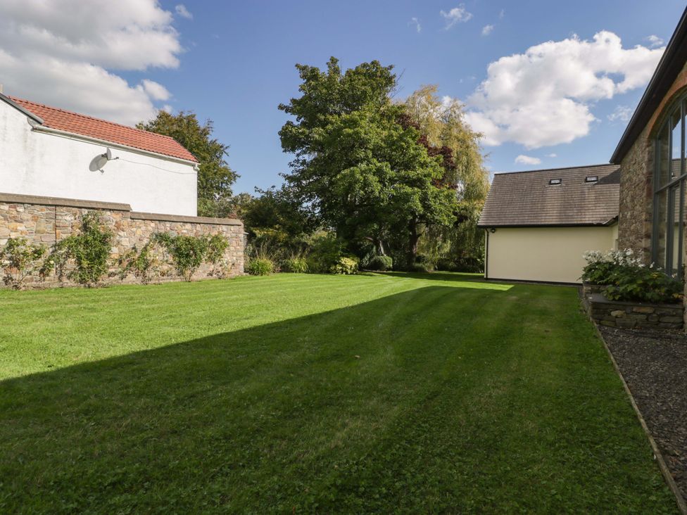 A garden with trees and grass at Heathcliffe House Caslteton near Cardiff