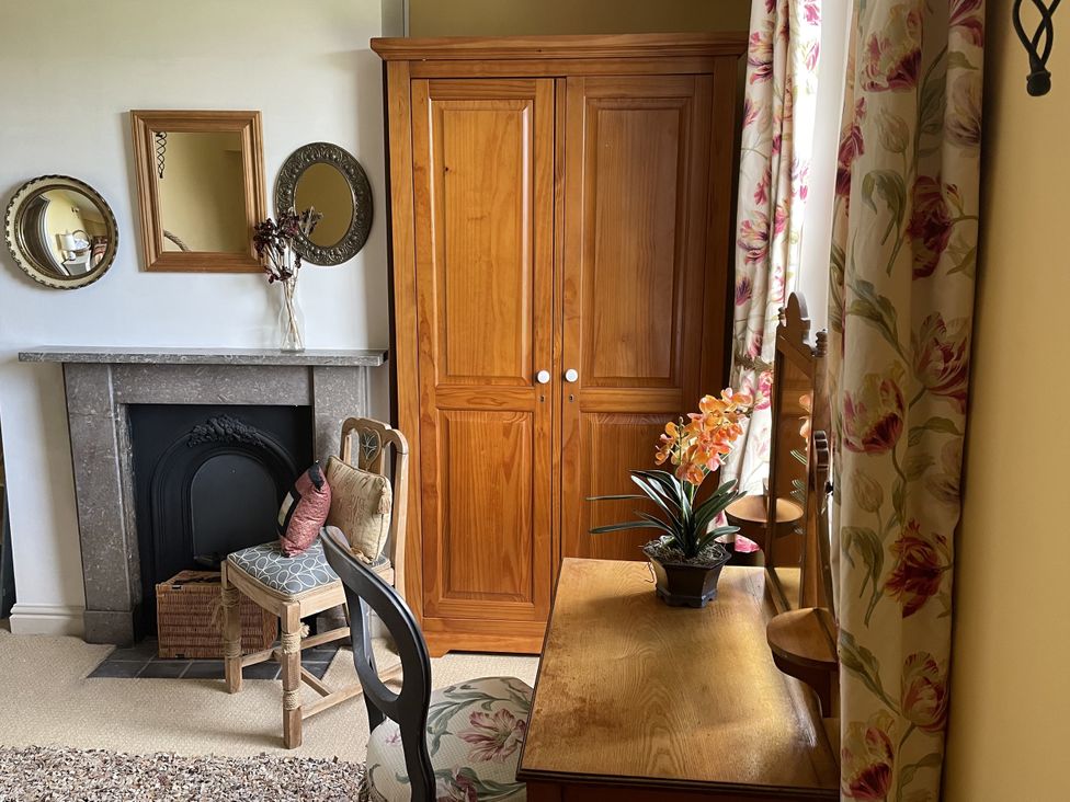 A living room with a wardrobe and a desk at 10 Upper Linney Ludlow