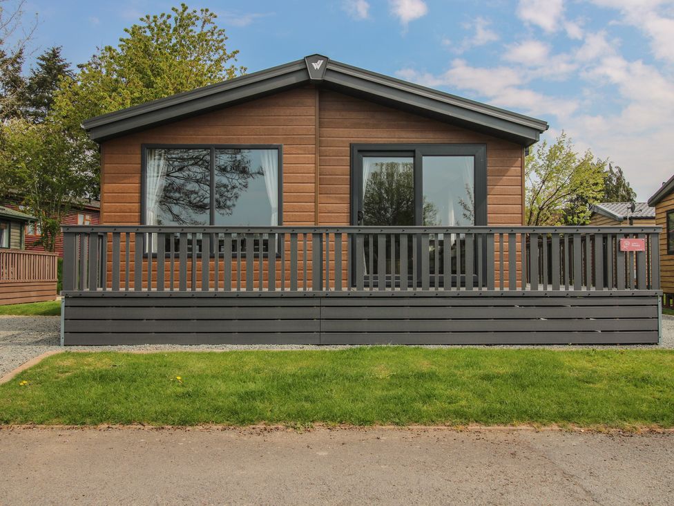 A cabin with large windows and a deck at Peony in Eardisland