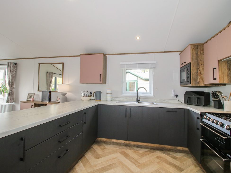 A kitchen with modern cabinets and appliances at Peony in Eardisland