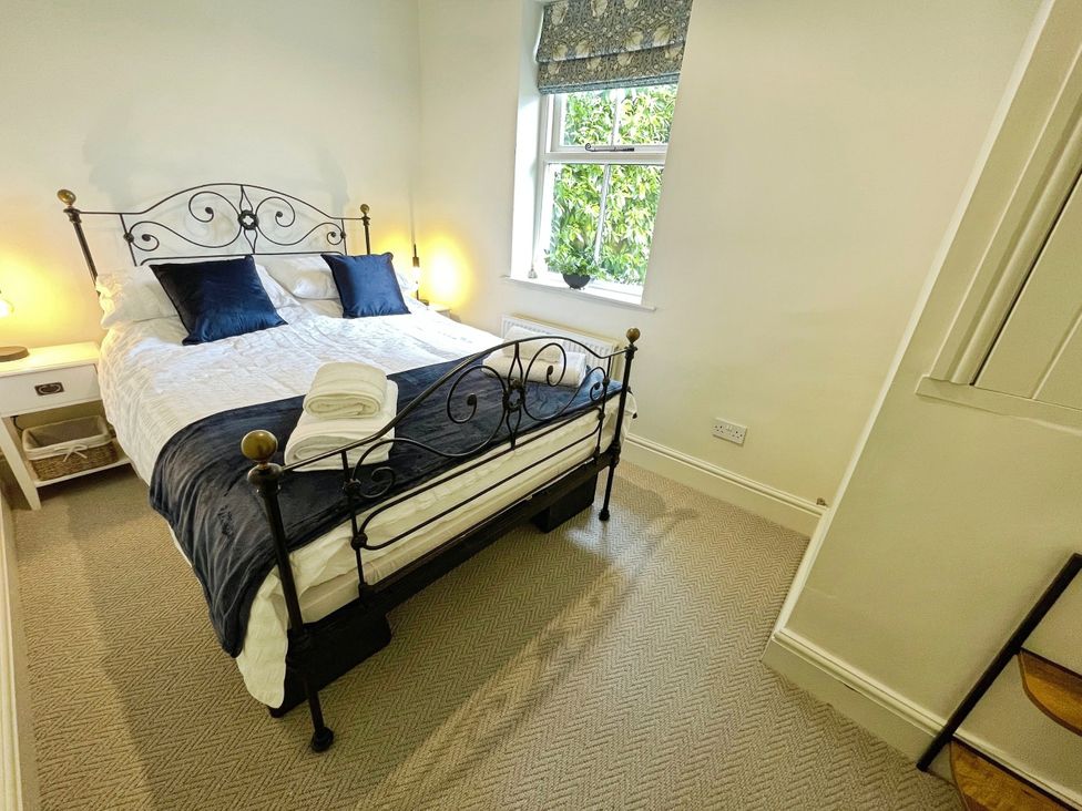A bedroom with a bed and nightstand at 3 Chapel Square Brookhouse near Caton