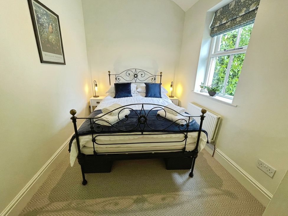 A bedroom with a bed and window at 3 Chapel Square in Brookhouse near Caton