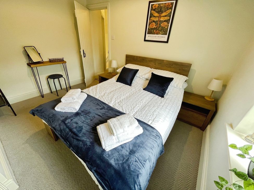 A bedroom with a bed and a small table at 3 Chapel Square Brookhouse near Caton