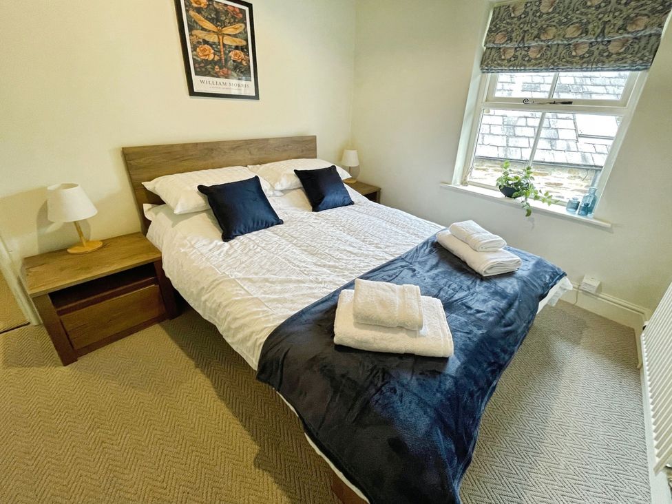 A bedroom with a double bed and lamp at 3 Chapel Square in Brookhouse near Caton