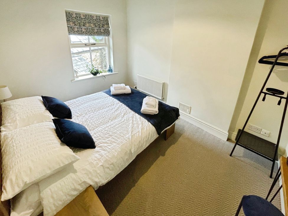 A bedroom with a bed and window at 3 Chapel Square Brookhouse near Caton