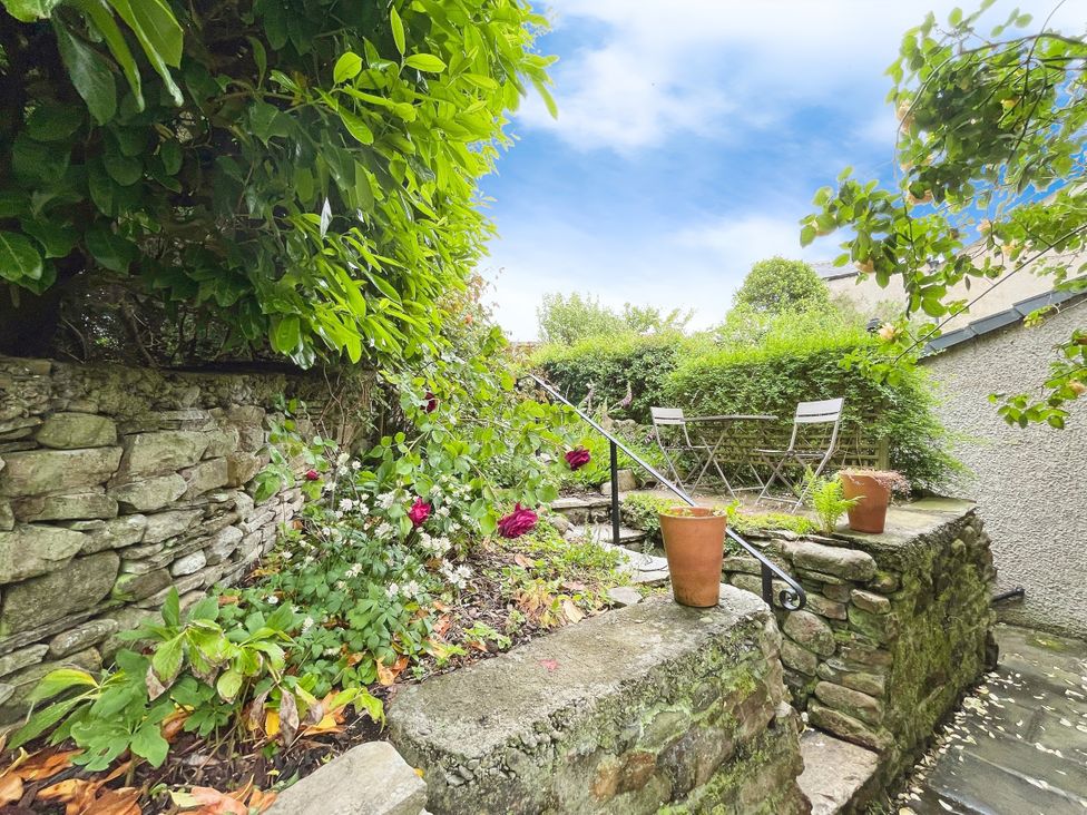 A garden with a stone wall and seating at 3 Chapel Square Brookhouse near Caton