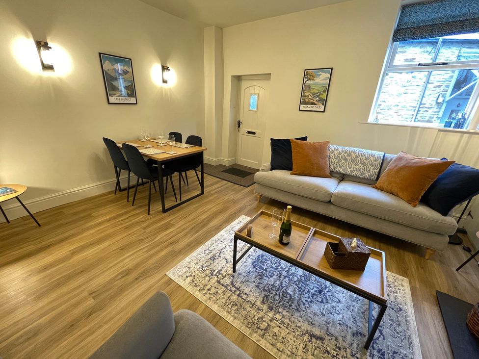 A living room with a sofa and dining table at 3 Chapel Square Brookhouse near Caton