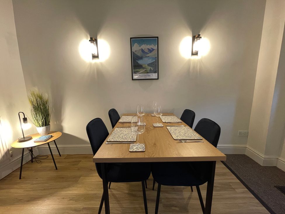 A dining room with a table and chairs at 3 Chapel Square in Brookhouse near Caton