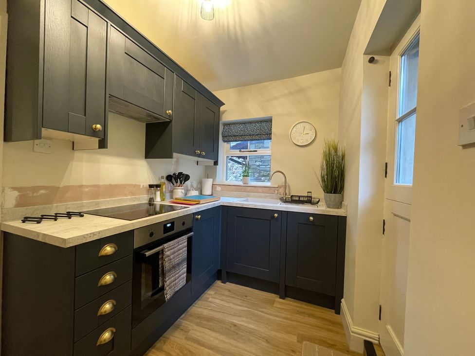 A kitchen with cabinets and appliances at 3 Chapel Square near Brookhouse